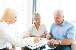 elderly couple meeting with their insurance agent